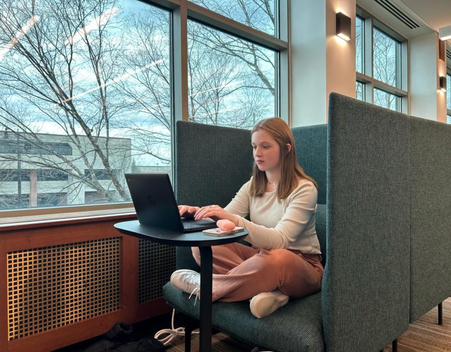 STUDY SESSION: Sophomore Selah Kearby works on homework in the Carmel Clay Public Library on March 9. Students have enjoyed studying in the library since it reopened in October. “I really enjoy the quiet atmosphere here at the library, it helps me to focus and do my best on whatever project Im currently working on,” Kearby said.