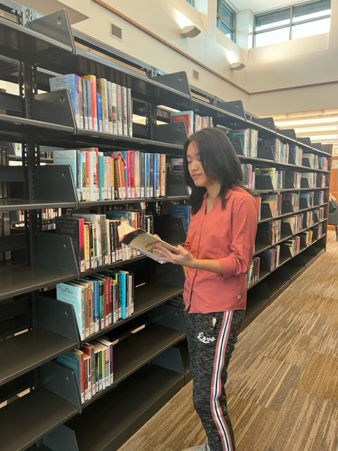 LIBRARY LOVE: Frequent library goer and sophomore Amber Shen visits the Carmel Clay Public Library on Mar. 6, 2023. The newly opened library has become a popular after school hangout and study spot for many students. “The new library is a great place for me to focus and get work done. Since it’s so close to the school I often go with friends to study in one of the study rooms after school,” Shen said.