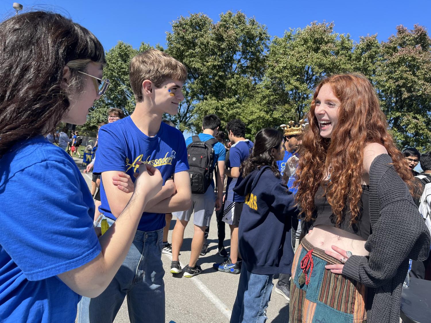 Ella Lipnik, Green Action Club (GAC) co-leader and junior speaks with CHS students at Homecoming to promote the GAC. The GAC had a booth with trivia questions pertaining to environmentalism and if students answered correctly, they won a prize. 