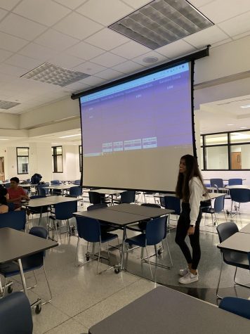 Darshini Shankar, social media manager and senior, reads a Kahoot question during the HOSA game night on Nov 4. The game night raised money and created stronger club connections.