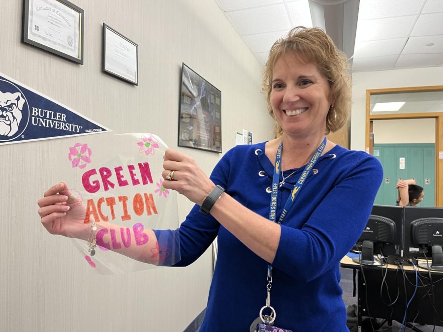 Carey Anderson, Green Action Club (GAC) sponsor, holds up one of many art projects made by club members. She said members utilized lamination scraps to create the art in order to encourage environmentalism around CHS. 
