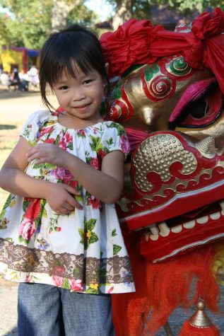 Emily Hahn smiles for a photo next to a chinese dancing lion. Hahn said that the only time she visited China was for about two weeks in 2011 when she was six years old. (Submitted Photo: Emily Hahn)