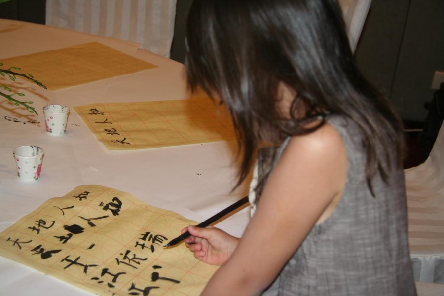 Emily Hahn learns how to write in Chinese. Hahn said that her parents did her best to educate her about her culture.(Submitted Photo: Emily Hahn)