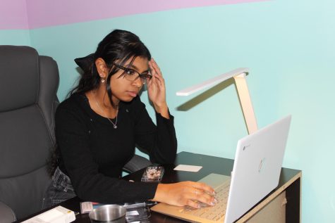 Junior Pragathi Arunkumar studies in her room on Dec 16, 2022. Arunkumar said “This year I’m going on vacation, but it’s a bit stressful because I have so much schoolwork to do.”