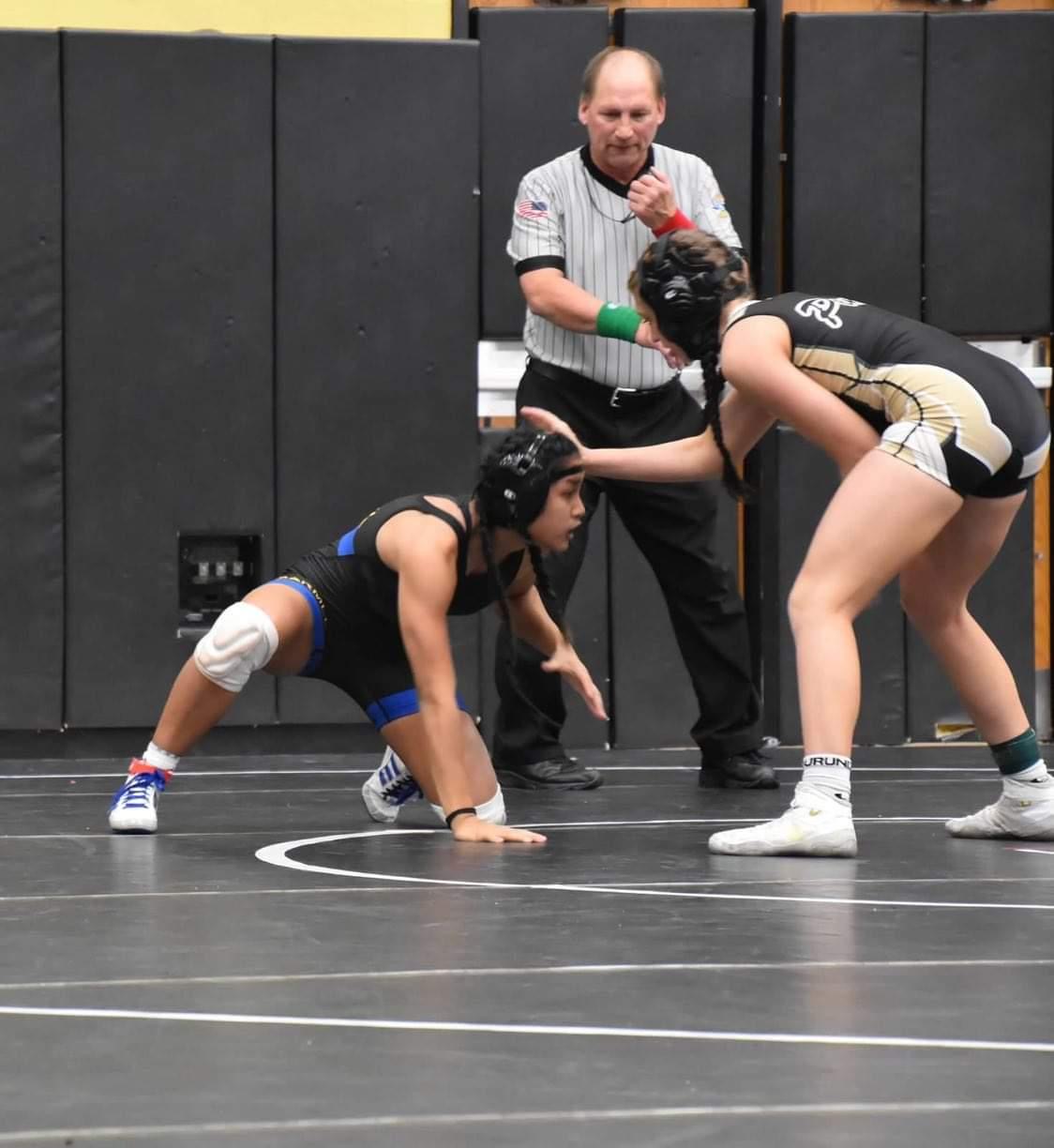 Junior Chloe de Leon wrestles against Penn on Nov. 19. De Leon said, “Everyone [on the team] is a surprise. I’ve had really low expectations for myself going into this season. I can do in practice, any moves I can learn in practice and actually execute well in a match, thats a win for me. I don’t really have to win to feel proud of myself.” Photo submitted by source.