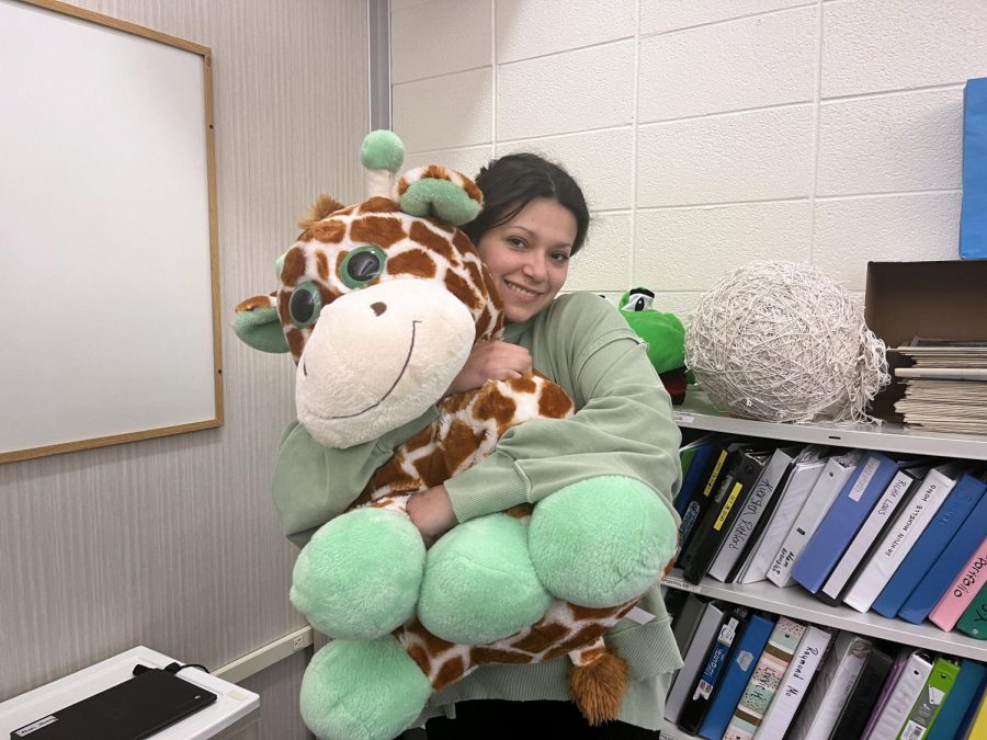 Senior Gloria Sanchez is holding a giraffe stuffed animal. She said that having an inner child is a good thing. 