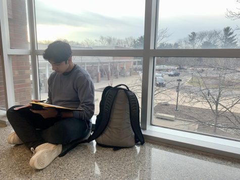 Junior Sanay Bahl works on homework in the catwalk before school on Tuesday, February 7. He said he can focus better when exposed to natural light.
