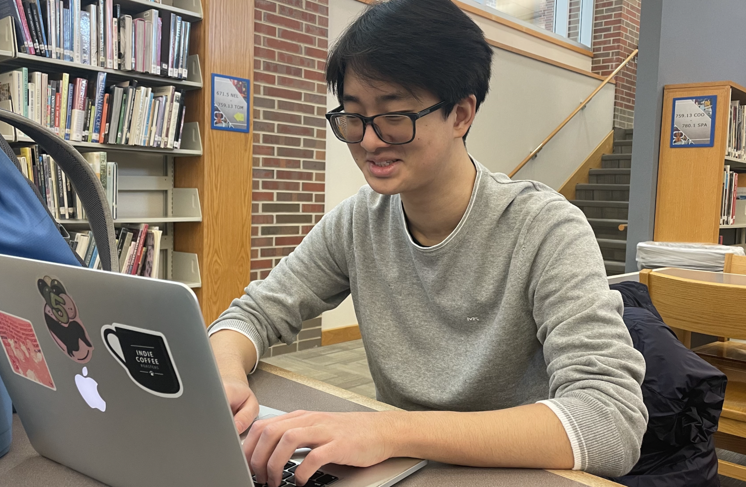 Senior Eric Yang works on homework during his release block. As a member of the Transition to College (TCP) Program, Yang comes in and out of the school multiple times a day, and thinks the safety of school entry can be improved.