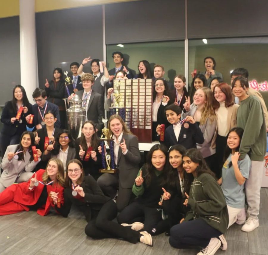 Speech and debate team pose after with their trophies after placing first in the State competitions.
