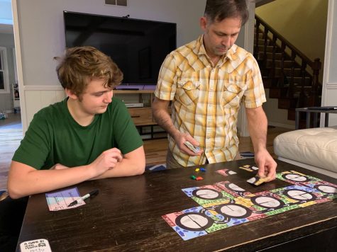 Freshman Franklin Vrtis plays his game Roundabouts with his father. He said that he was inspired to make a tile based game from another popular card game, Carcasonne.