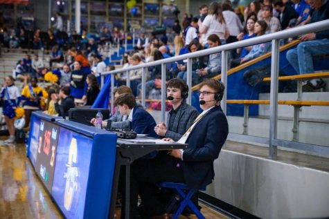 Connor Gratigny watches and commentates on mens varsity basketball game. Gratigny said he has to be careful on what he says to be sure he doesnt include his own personal opinions.