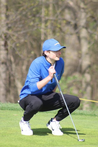 Austin Kent, men’s golfer and senior, lines up a shot while competing against Brownsburg. Coach Shelton said that the team has a great chance to be a top contender for the State championship. 