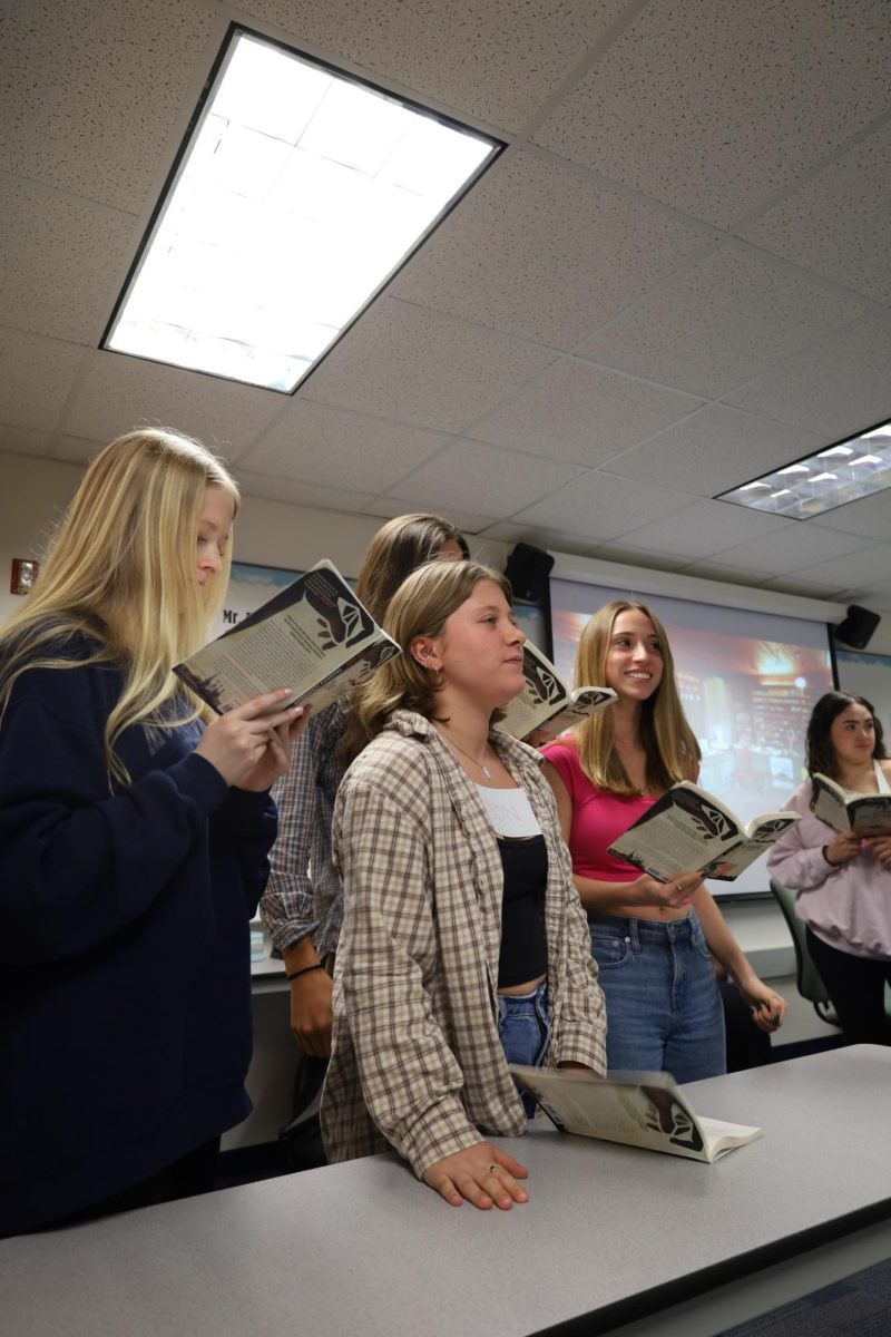 Darby Miller, junior, and IB English student, along with other IB Literature students, read and act out a play during their class on April 24. The class picked parts and read the play throughout the week to learn more about different literary elements and devices.

