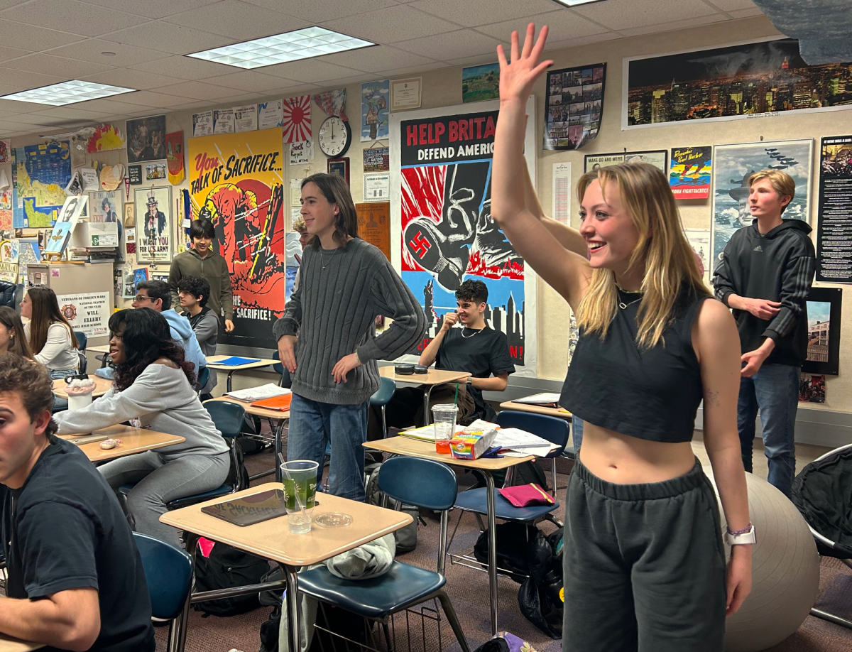  Junior Anne Byron raises her hand during a dance break during IB Theory of Knowledge on April 17th. The students spoke about Michael Jackson and danced along to a Thriller inspired Just Dance.