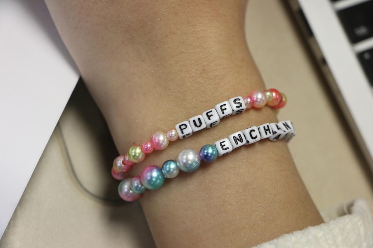 Junior Alivia Conz wears her “Puffs” bracelet to promote the production in her precalculus class on Nov. 3. Conz was a part of the technical theatre crew for the play and said it will debut next Thursday. 