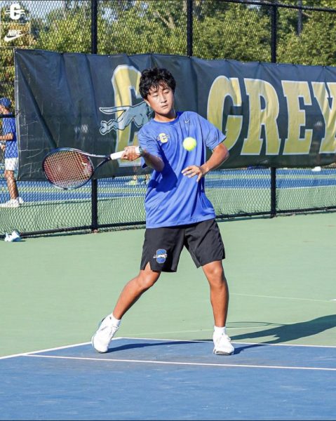 Rocky Li, tennis player and junior, plays in the match against Guerin Catholic. Coach Brunette said the team will be a top contender for the State championship in late October.