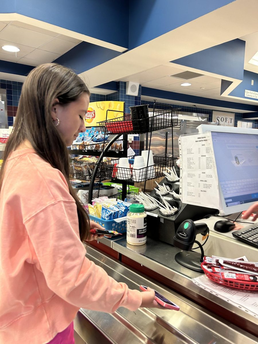 Sophomore Kaitlyn Ho scans her school ID to purchase a snack on September 19, 2023. CHS continues to add more options in both snacks and school lunches as students such as Ho say they want more variation.