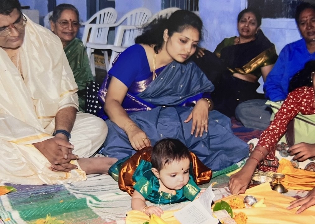 Sophomore Bhavana Rupakala participates in an Indian cultural event called “Annaprasana”, in which infants choose objects that are supposed to indicate their future careers. Rupakala said most people she met in the United States were friendly toward her. (Submitted Photo: Bhavana Rupakala)