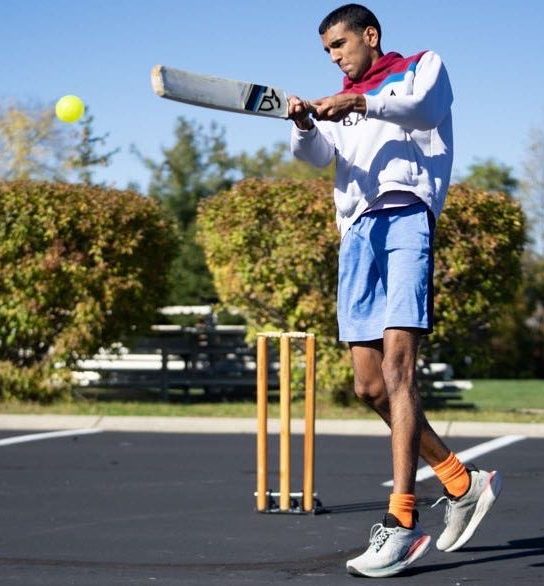 Aayush Singh, Junior plays cricket in a parking lot on Oct 22. 2023. Singh said he believes Cricket is becoming a more popular sport every day.