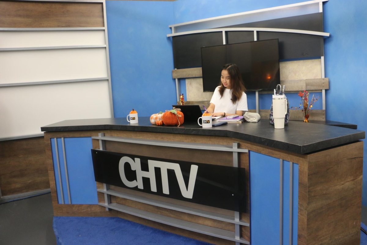 Rebecca Lee, CHTV news anchor and senior, works at the CHTV studio. CHTV+ was released to offer many benefits to their members such as early access to CHTV content.
