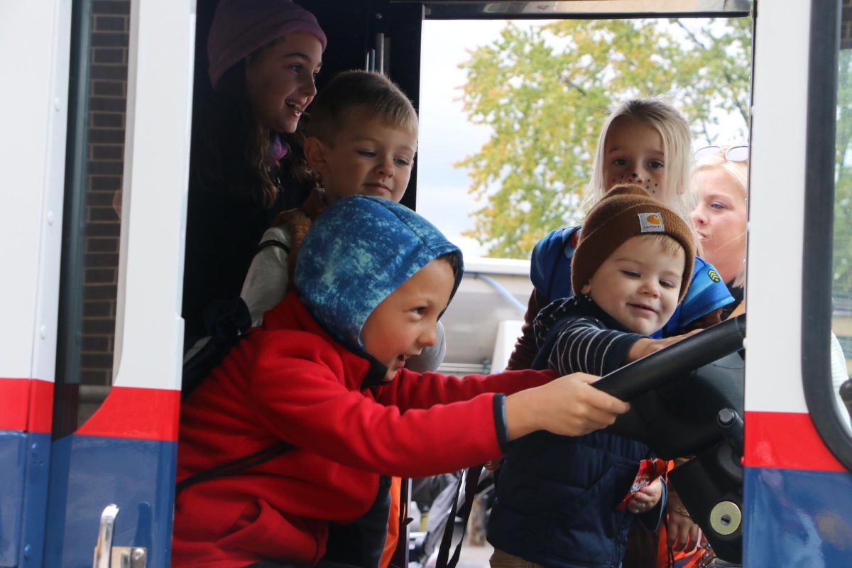 A group of friends gather in an old mail truck at The Arts in Autumn Event in Midtown on Oct. 14. One of the activities available at the event was Touch a Truck where kids got to play in old mail trucks and big street department trucks.