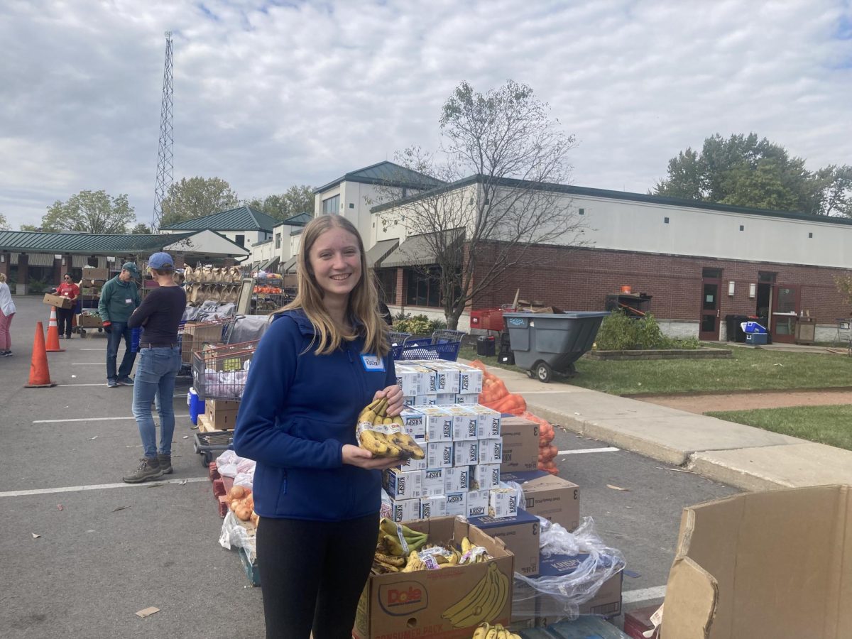 Rachel Lehner, volunteer at Crooked Creek Food Pantry (CCFP) and sophomore, poses as she helps distribute food items on Oct.11. Lehner talks about how she had worked at CCFP 12 times and has done 31 hours of volunteer work in total. (submitted photo by Rachel Lehner)