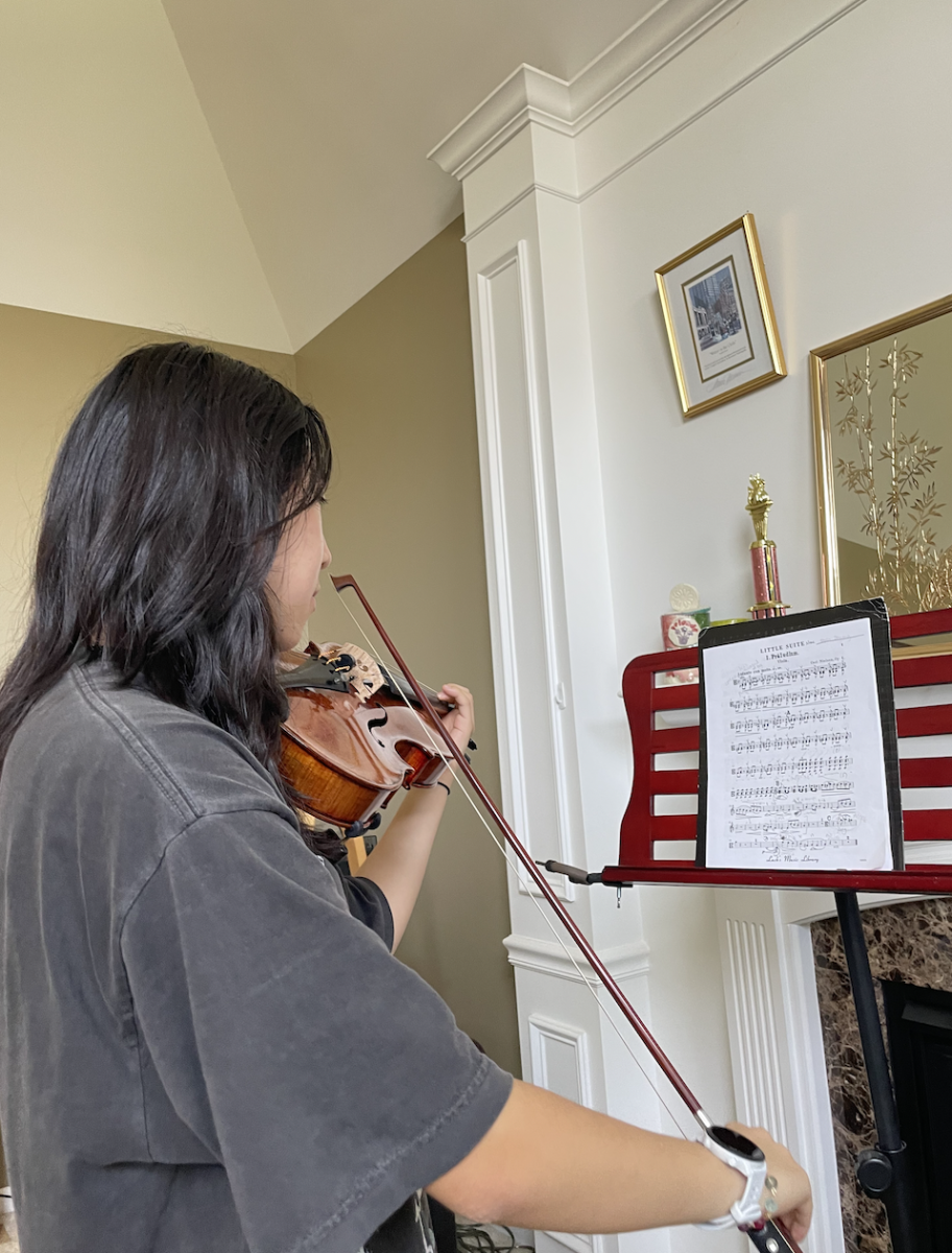 Taylor Zhuang, member of Camerata Orchestra and sophomore, practices fall concert music. According to Zhuang, the orchestras have been working up to the concert all semester.