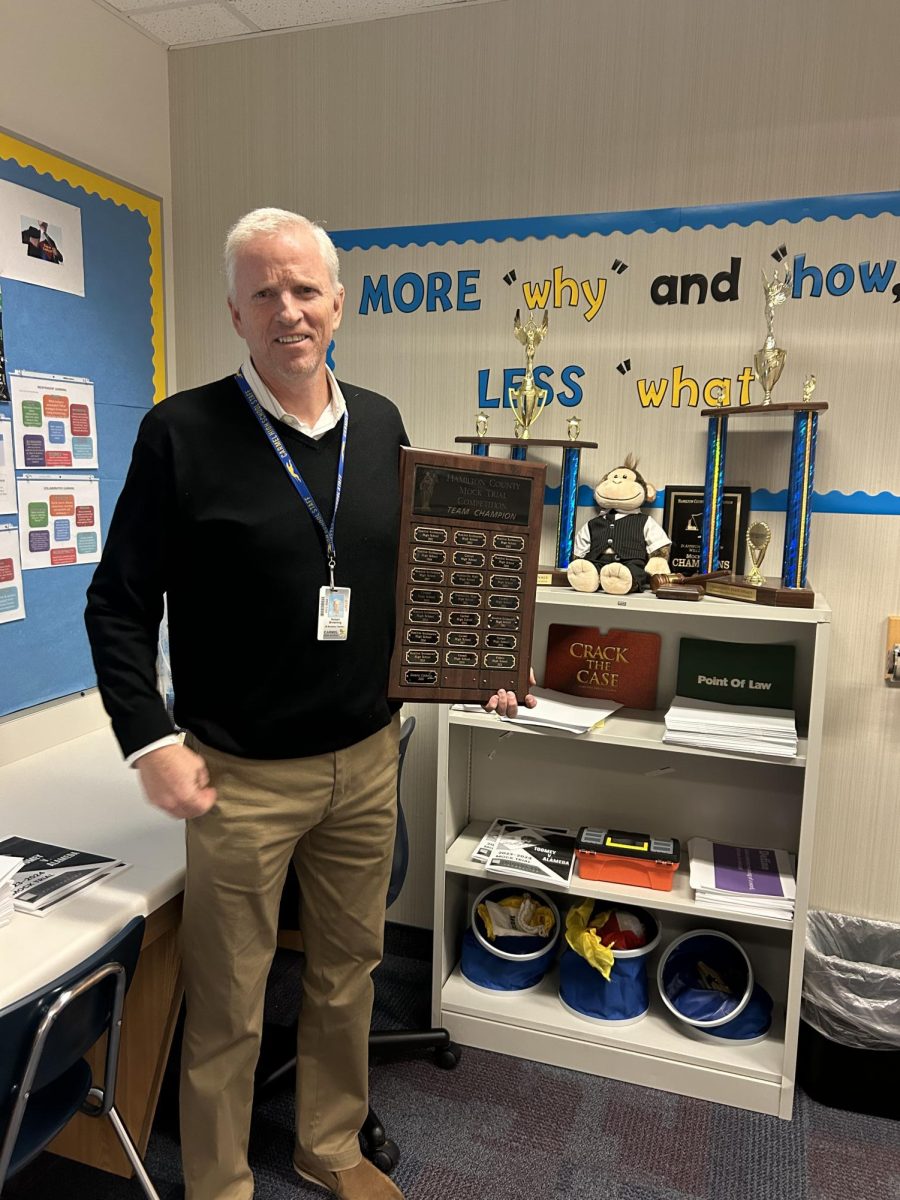 Mock Trial Sponsor Robert Browning holds the plaque of past Carmel victories at county in club room F102. “It’s great how we’ve been able to continue to win so many awards, these people are always so talented,” Browning said.