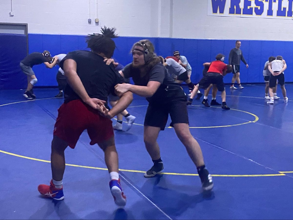 Senior Arty Bryant (left) squares up against sophomore Lucas Brock (right) during a practice on Nov. 16 before the first meets of the season. Head Coach Ed Pendoski said duals help players hone in on their skills. 
