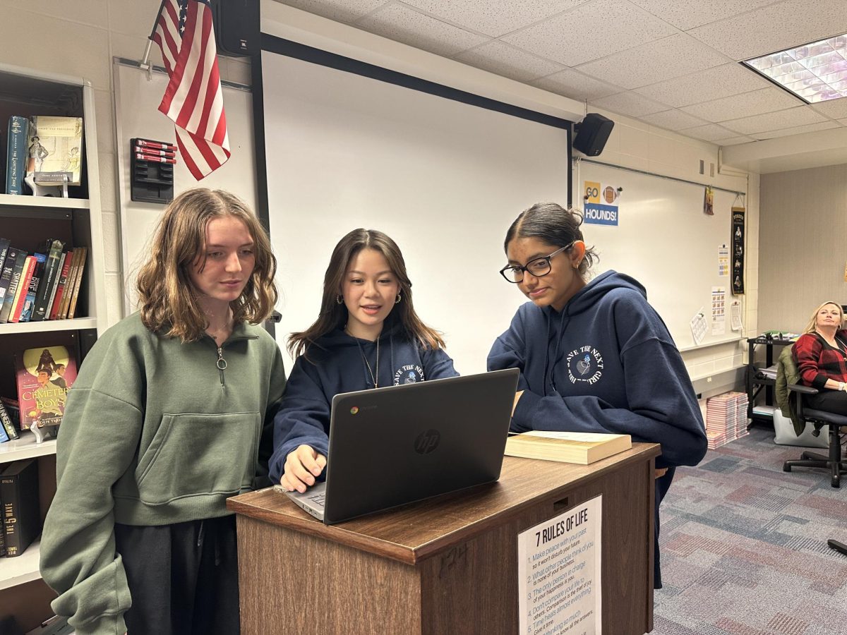 Greta Griffin (left), HSTNG secretary and junior, Cocoa Kubo (middle), HSTNG president and junior, and Arya Patel (right), HSTNG treasurer and junior, look over their presentation for the club meeting on Dec. 14. Kubo said, I decided to start the club because I’m really interested in things like true crime as well as just advocating for my community.
