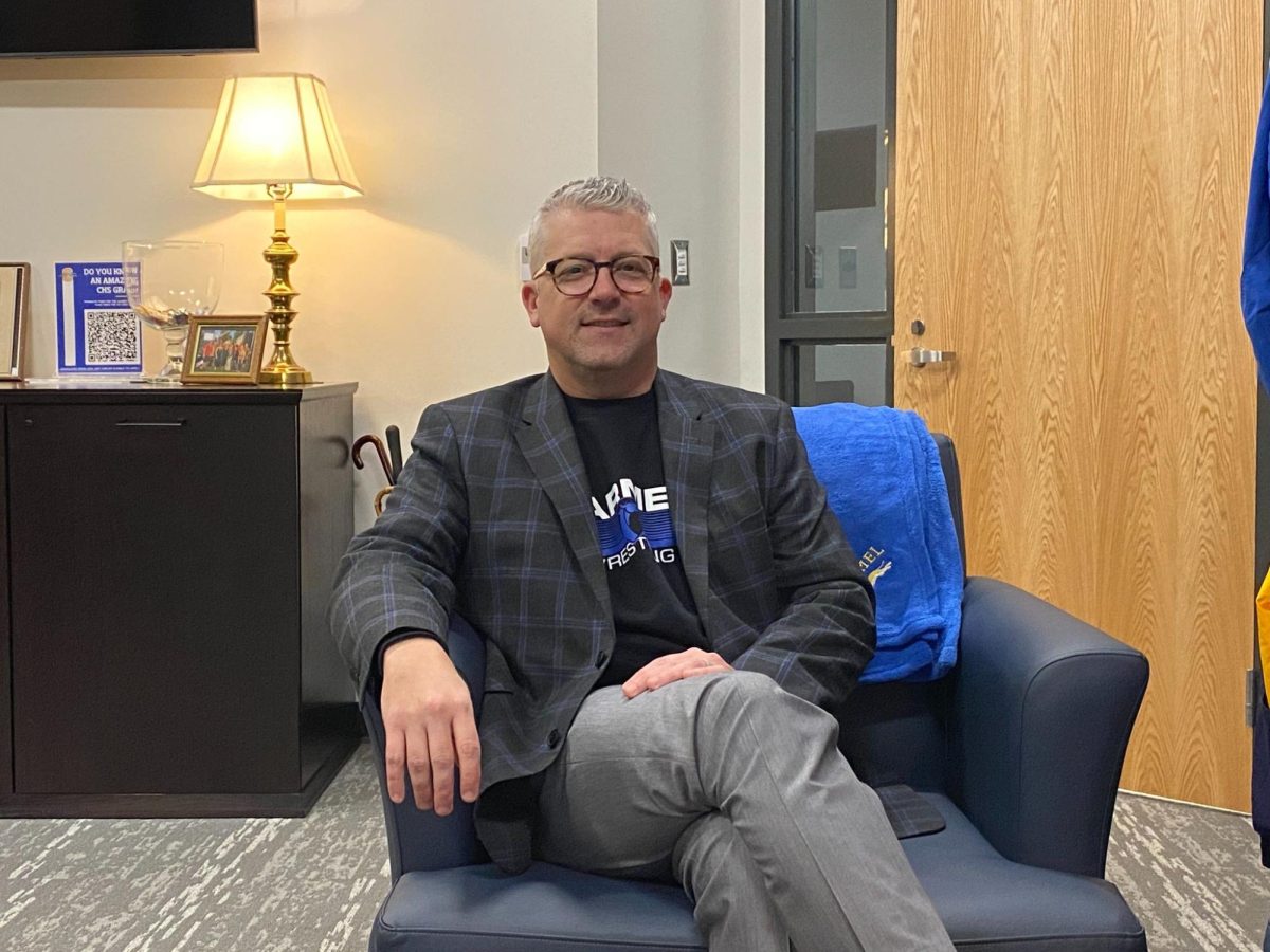 Principal Tim Phares sits in his office. Administration is monitoring the impact of the Polytechnic Department construction in the Freshmen Center parking lot. Phares said buses must make sharper turns to line up during school start and dismissal times but efficiency has not been affected. 