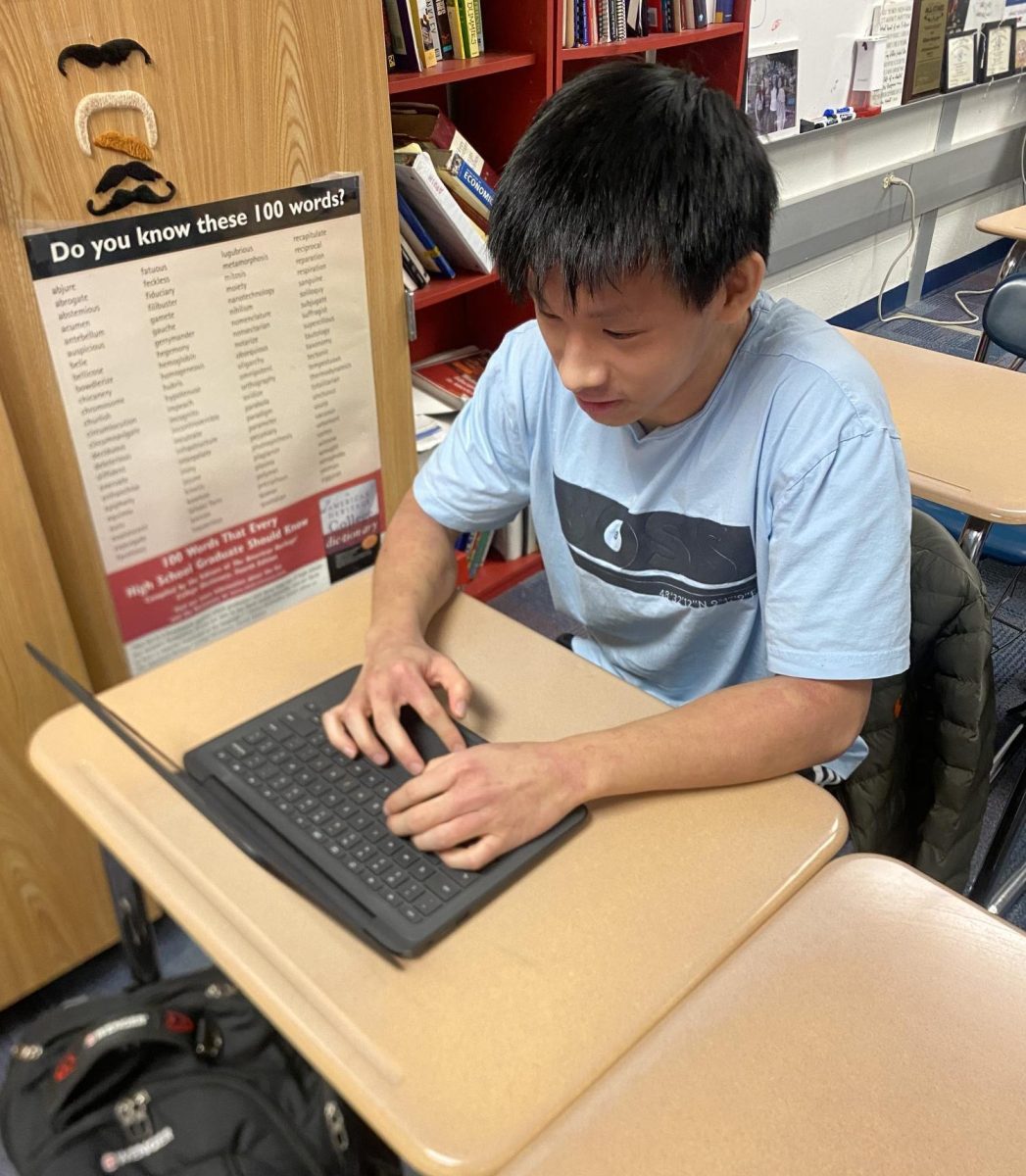 Sophomore Jasper Zhu writes code on his computer. Zhu said, (I learned how to code when I) was in seventh grade, I took a coding course and I was just thinking that it was an easy class to just chill in, but I ended up finding out that it was actually pretty fun.
