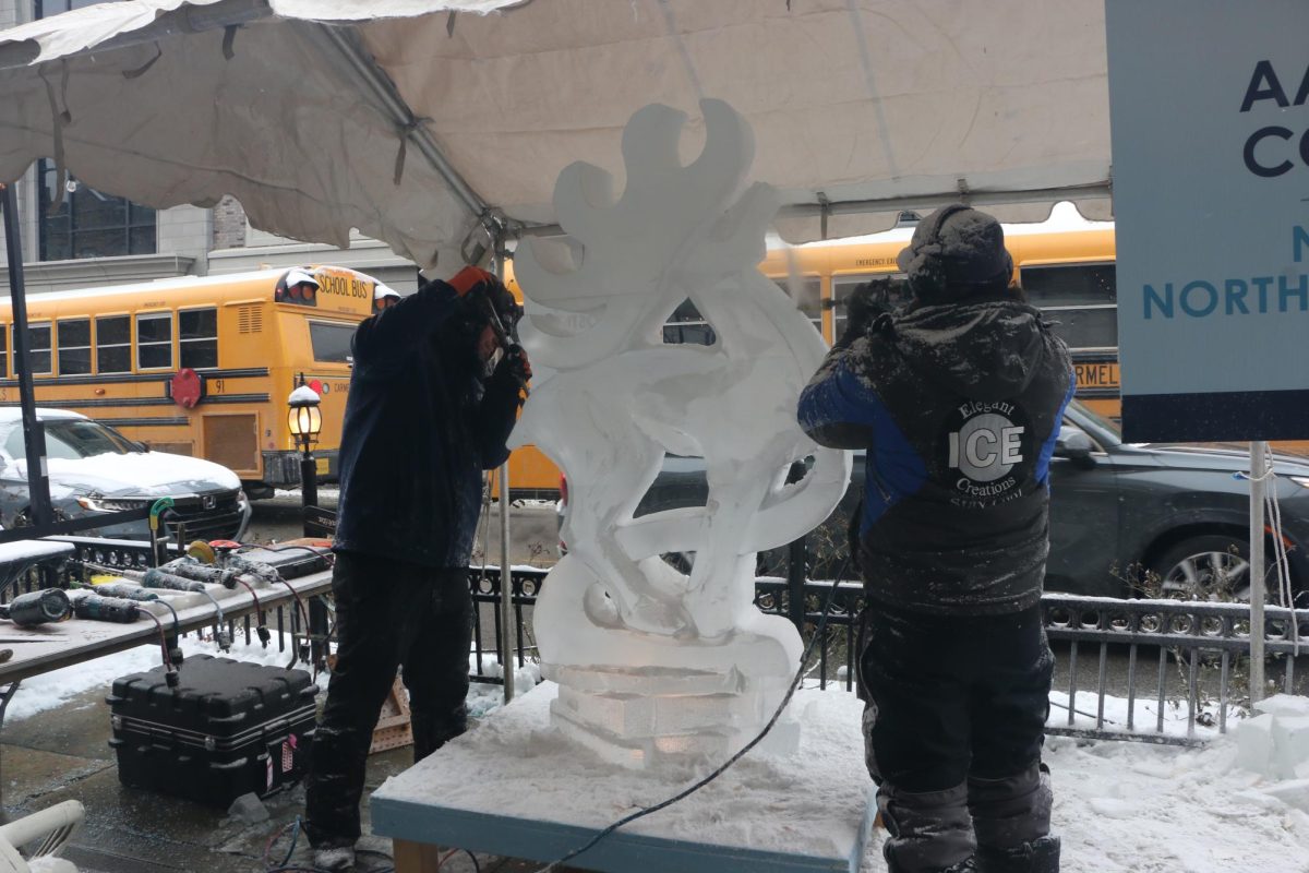 Elegant Ice Creations workers sculpt a reindeer on Jan. 19 at the Arts & Design District. From 4 to 8 p.m., the artists worked on and showcased their ice carvings.