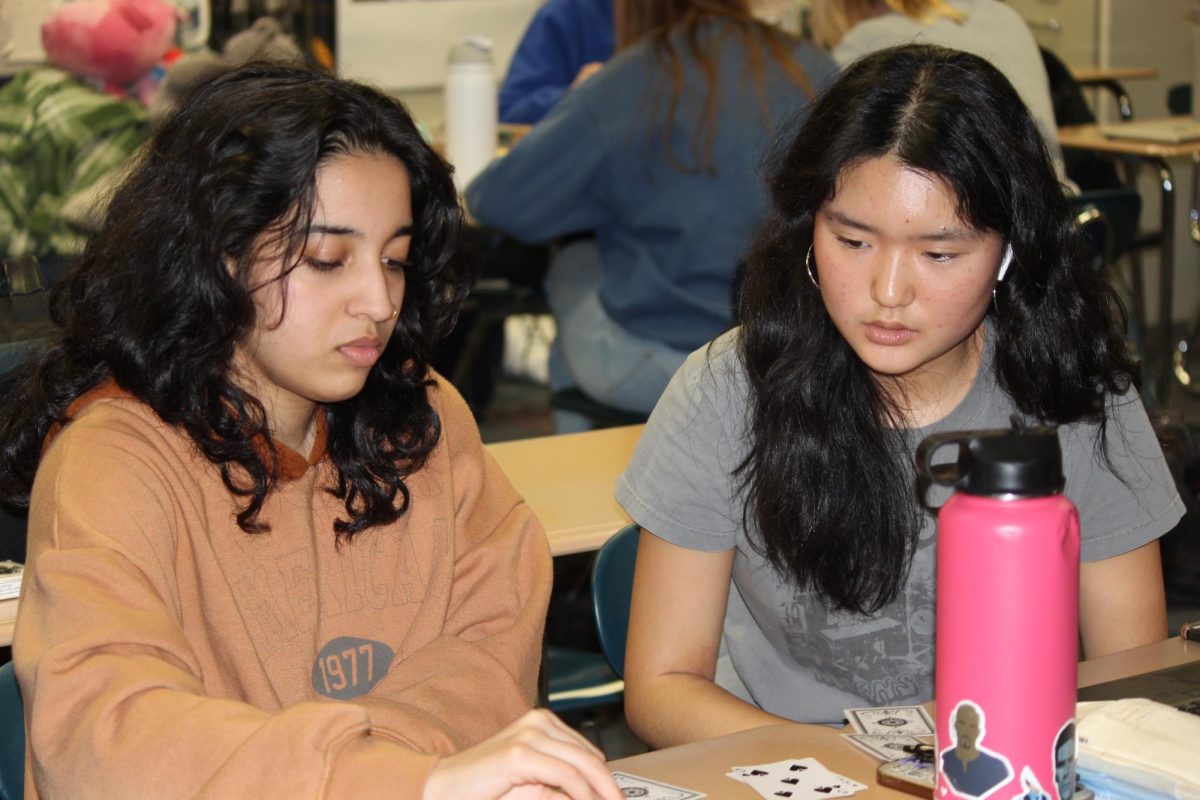 Seniors Arushi Nadagatti and Amanda Pan play a card game during SSRT on Dec 18th, 2023.