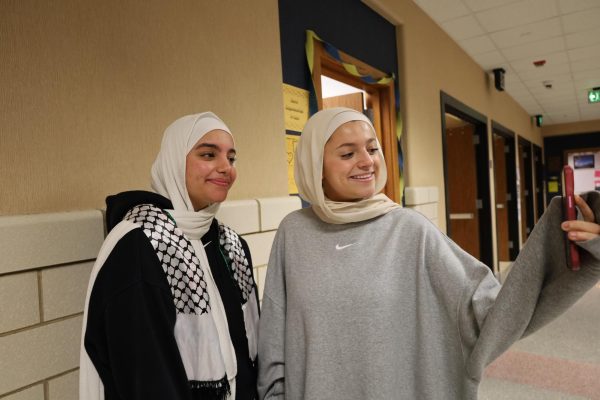 Juniors Mariam Morad (left) and Laila Abumahfouz (right) take pictures during SSRT on Feb. 16, 2023. “I started wearing the hijab because many Islamic scholars have agreed that wearing the hijab is mandatory,” Morad said. “However, this is not the only reason I wanted to wear the hijab because it represents who I am as a Muslim.” 