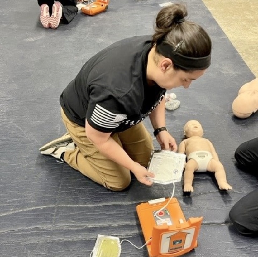Ashley Williams, Master Patrol Officer and SRO, practices CPR on a fake baby in order to renew her CPR certification. Williams said following established guidelines and getting new certifications every year help SROs better protect students.