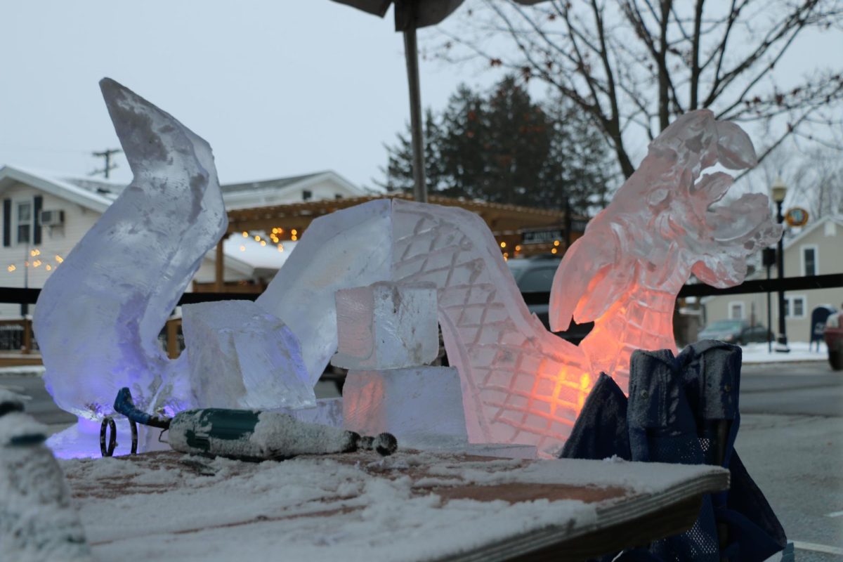 Elegant Ice Creations workers sculpt a dragon on Jan. 19 at the Arts & Design District. From 4 to 8 p.m., the artists worked on and showcased their ice carvings.