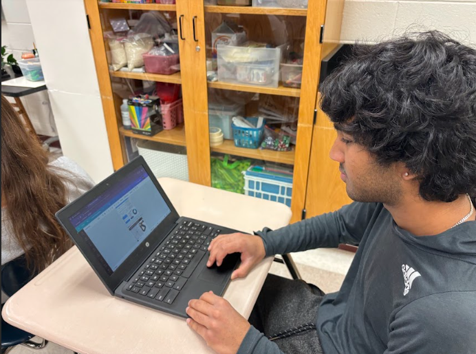 Junior Sriyesh Sirineni works on his Integrated Marketing Campaign paper on Feb. 16 for upcoming DECA competitions. Sirineni said his motivation for DECA comes from the opportunity to travel to California and the social aspects during competitions. 

