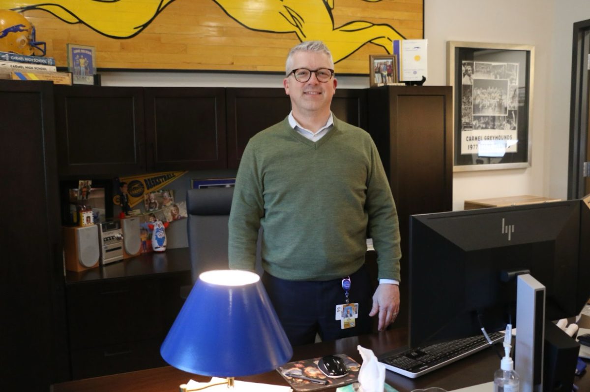 Principal+Tim+Phares+stands+at+his+desk+in+the+administration+office+on+March+19.+Phares+said+seniors+should+begin+preparing+for+senior+and+graduation+events+in+April+and+May.