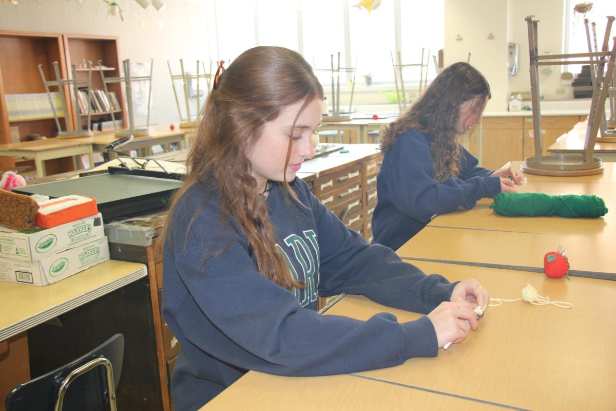 Junior Maggie Conti works on a crochet project during the Crochet Club meeting on Mar 19, 2024. I really enjoy crocheting because I can create different things for my friends or make creative items that are more practical which I will use in daily life, said Conti.
