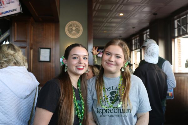 Two students celebrate St. Patricks Day at Shamrock the District on March 16. Beth Hohlier, the owner of Muldoons, said, We have bagpipers, bands, karaoke and more...We have Irish bingo thats new this year inside the tent.