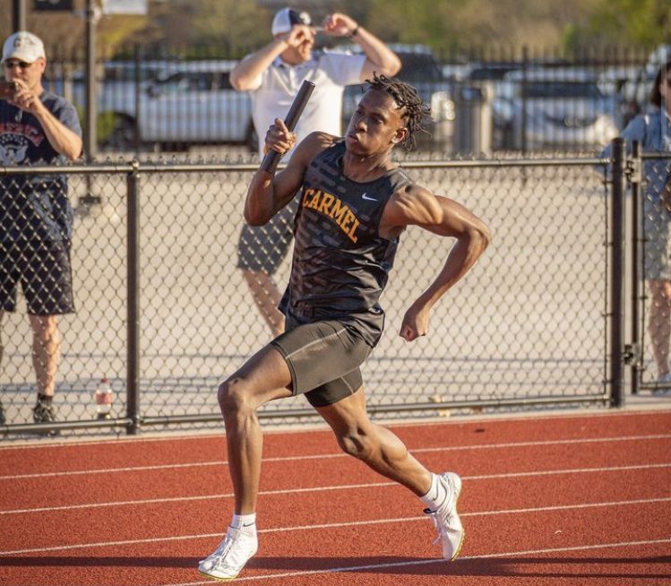 Adom Quist, track and field runner and senior, runs in the track meet at home. Coach Altevogt said that the team will be top contender for the State championship in early 
