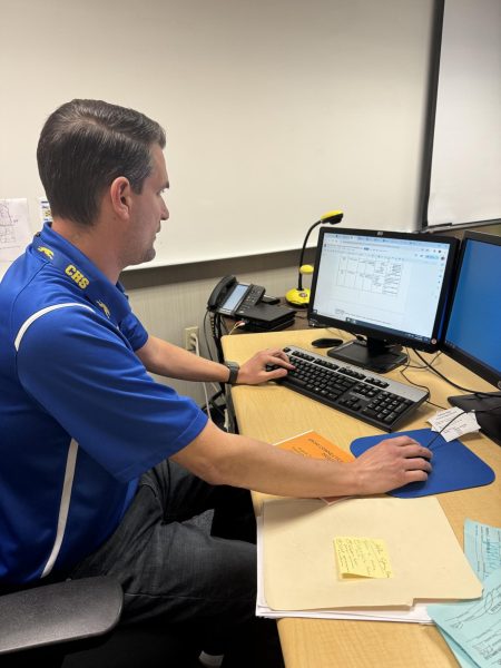 GKOM sponsor Ryan Ringenberg views the schedule and assignments for upcoming meetings. Ringenberg said they cover topics recommended by freshmen counselors to assist freshmen throughout the year.
