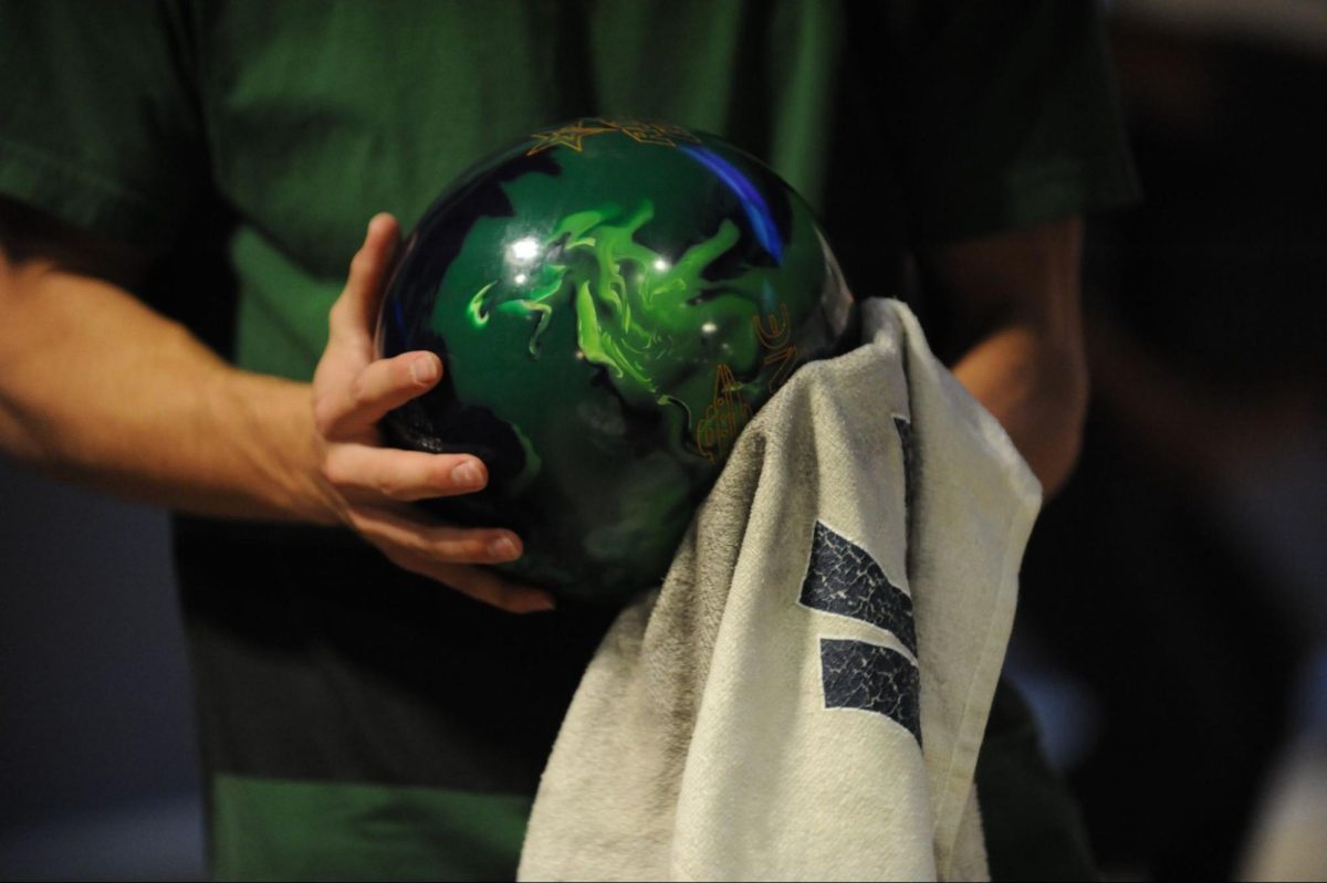 Senior Kevin Russo wipes off the oil from his bowling ball after throwing it. Russo said, “Wiping off the ball after every time you throw it is essential to consistency when bowling. If you do not wipe the ball, there could be residual oil, which can affect how the ball reacts when it goes down the lane. I always clean my balls in order to have a consistent reaction and always get a strike.”