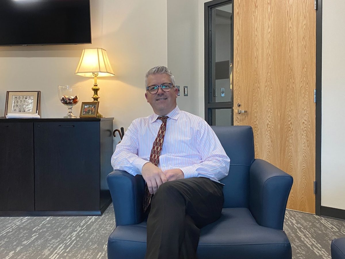 Principal Tim Phares sits in the Administration Office. Phares said ongoing and new construction projects will continue or start over the summer. Door 13 will be closed until the 2024-2025 school year.