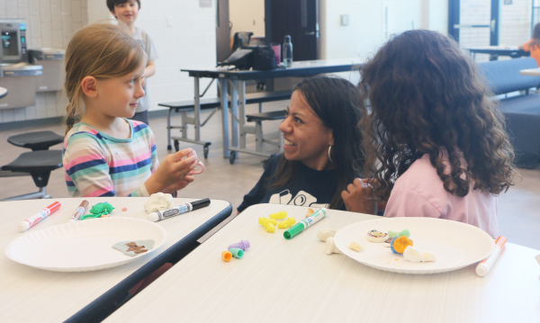 Junior Veronica Farrell interacts with a Carmel Elementary School student at her after-school job on April 30. Farrell said one of her favorite parts of her job is helping kids make crafts.