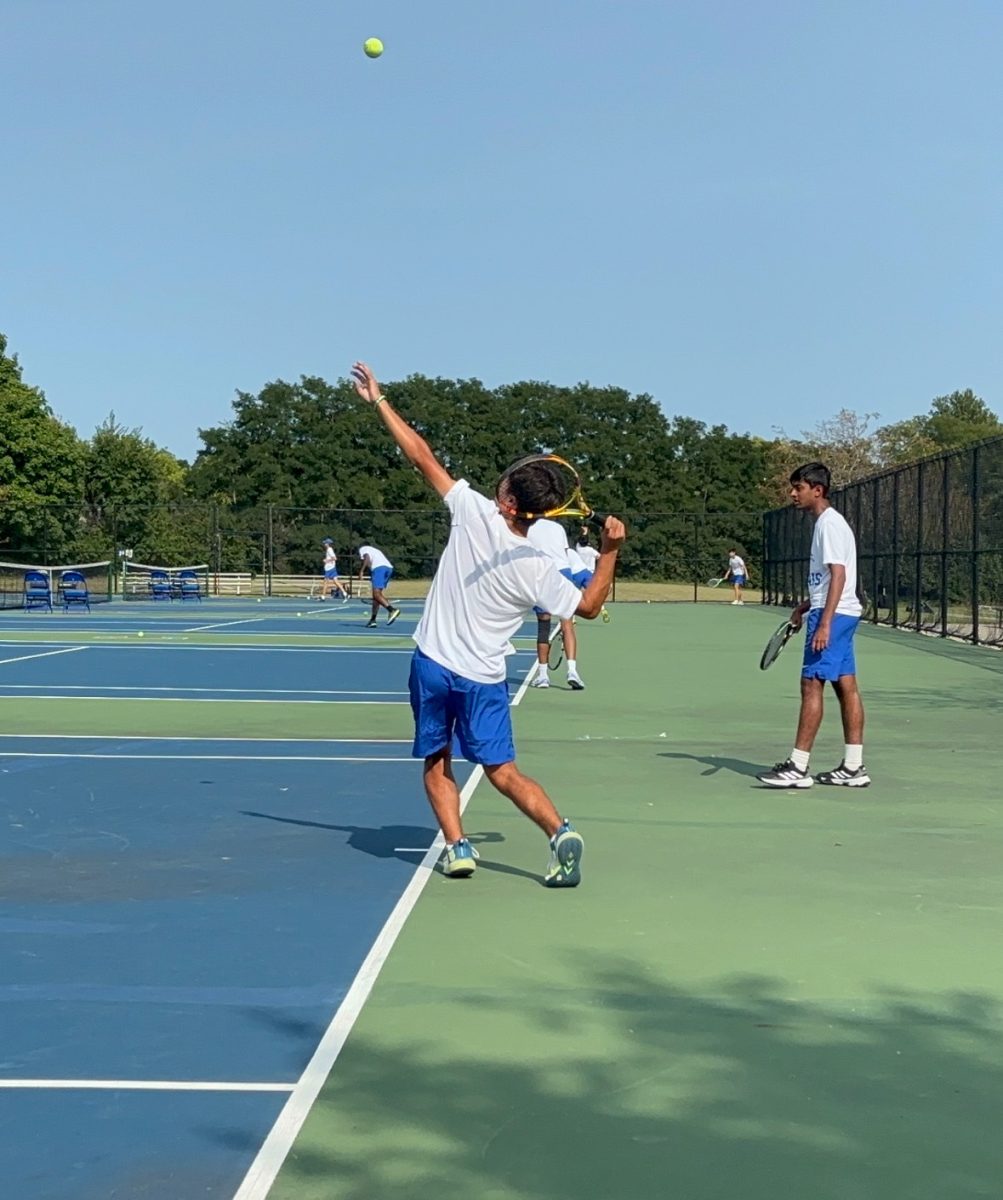 Andrew Kim, tennis player and junior, plays against Cathedral. Assistant coach Mark Branaman said that the team is enthusiastic, seeming to be gelling very well together.