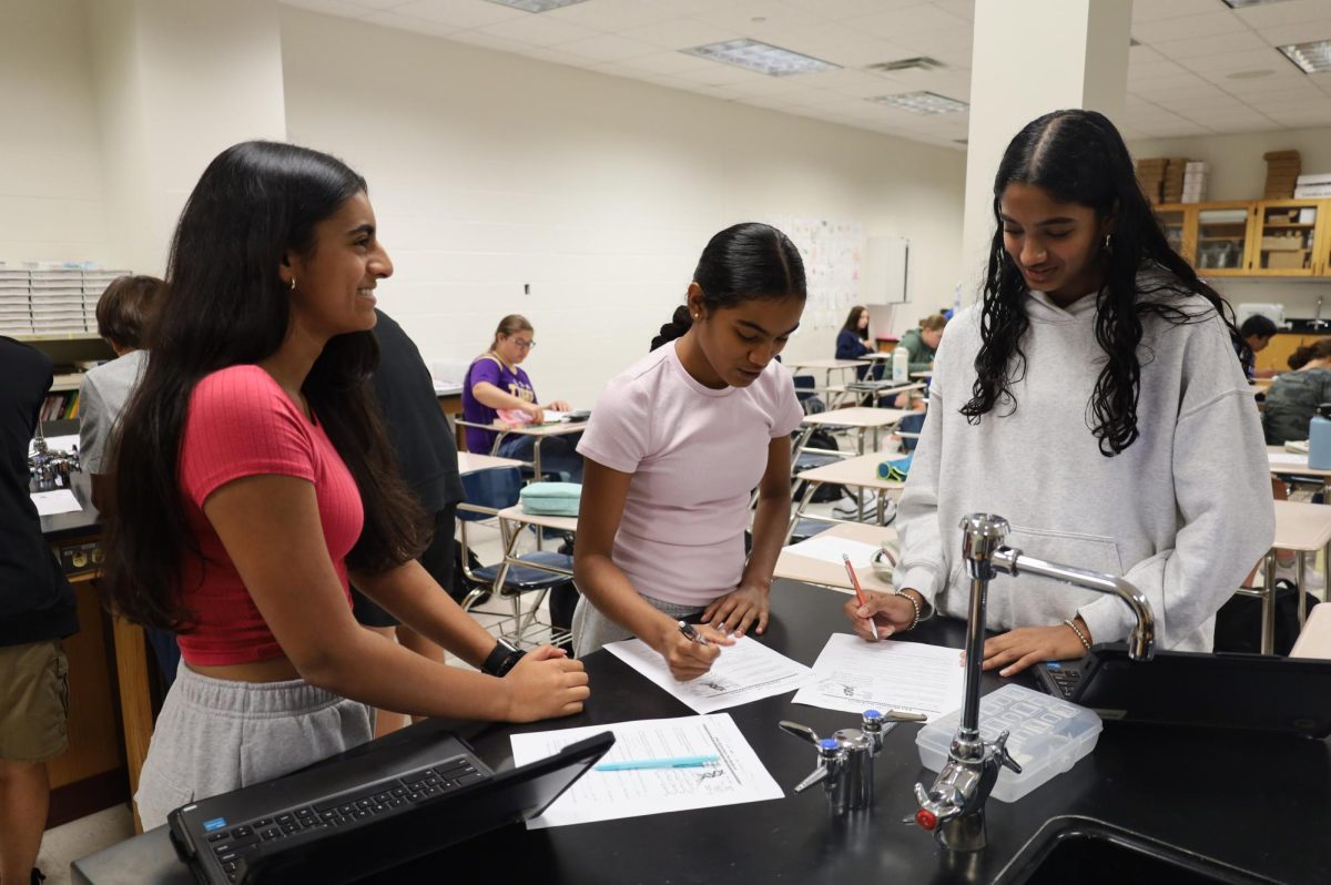 Freshmen Riya Chandra (left), Shravya Pillutla (middle) and Arna Jatla (right) studies DNA structure in principles of biomedical science (PLTW). The PLTW class focused on hands-on learning, and allowed students to explore biological concepts through group activities. "I like that [Conley] lets us watch videos and creates fun ways to explain concepts, and I like that he lets us work with our friends," Jatla said.
