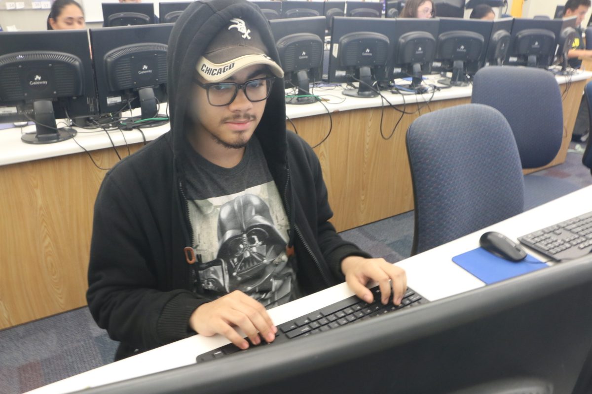 Senior Teagan McDonald works on his computer in cybersecurity on Sept. 25. Students worked on a presentation about the different types of malware during the class period. McDonald said, “I think that cybersecurity is important as it teaches young people, who are most vulnerable to cyberattacks, how to stay safe online.”