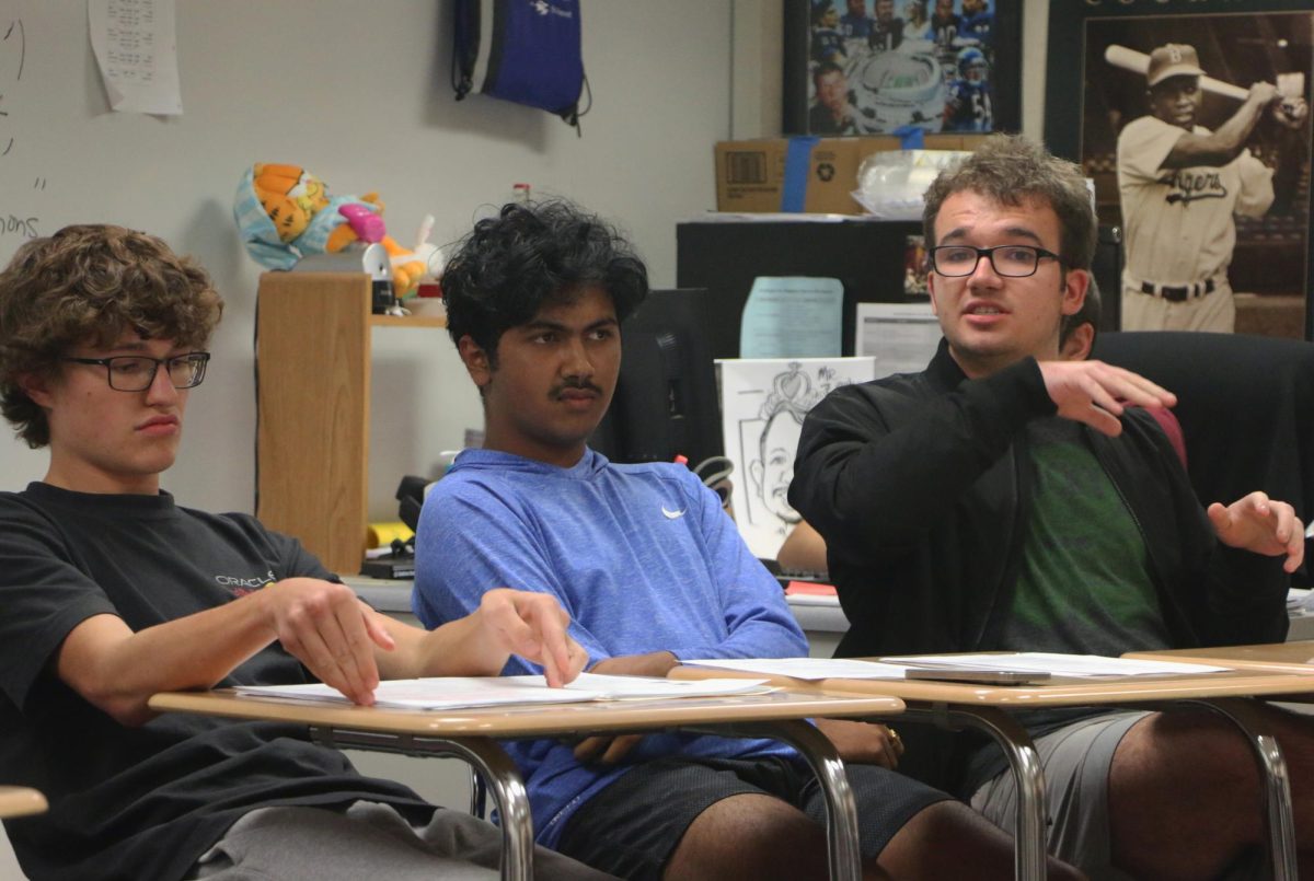 USING YOUR VOICE: Junior Grayson Miller(right) makes his argument during an after school debate on Oct. 24. The debate was organized by Democrats Club and Republicans Club.